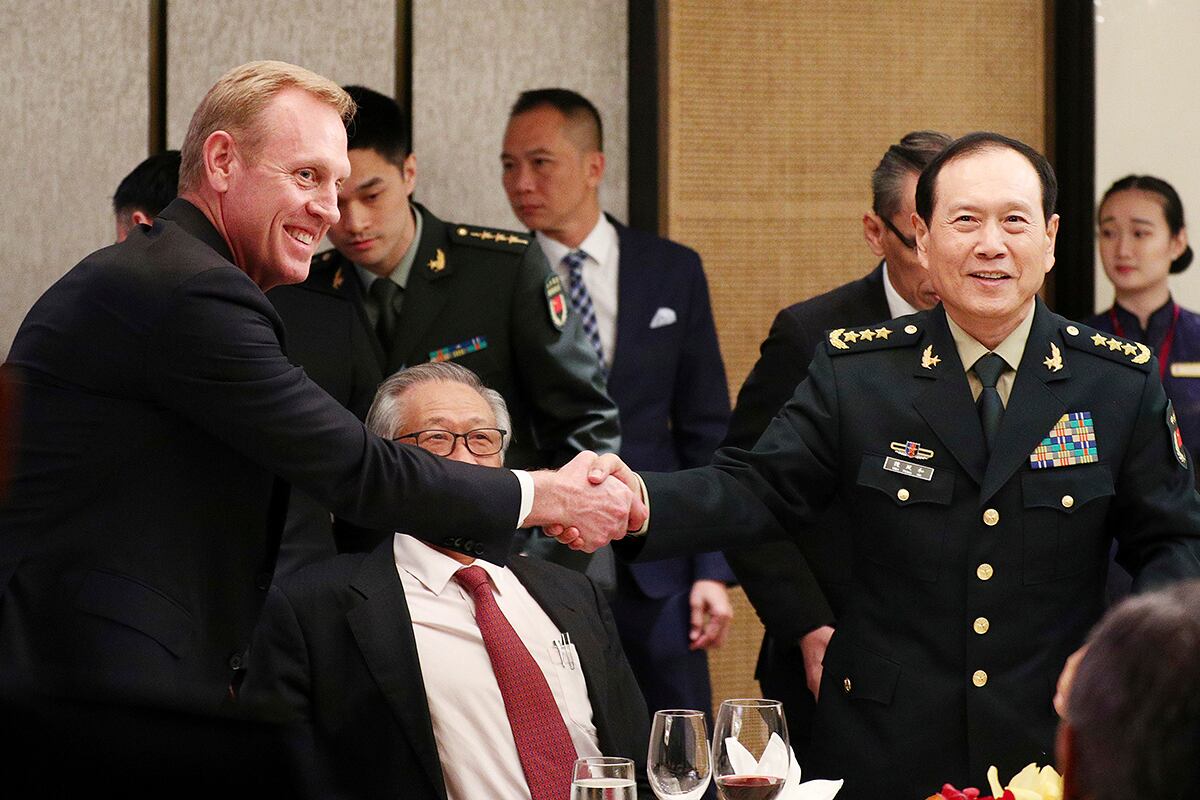 acting U.S. Secretary of Defense Patrick Shanahan, left, shakes hands with Chinese Minister of National Defense Gen. Wei Fenghe