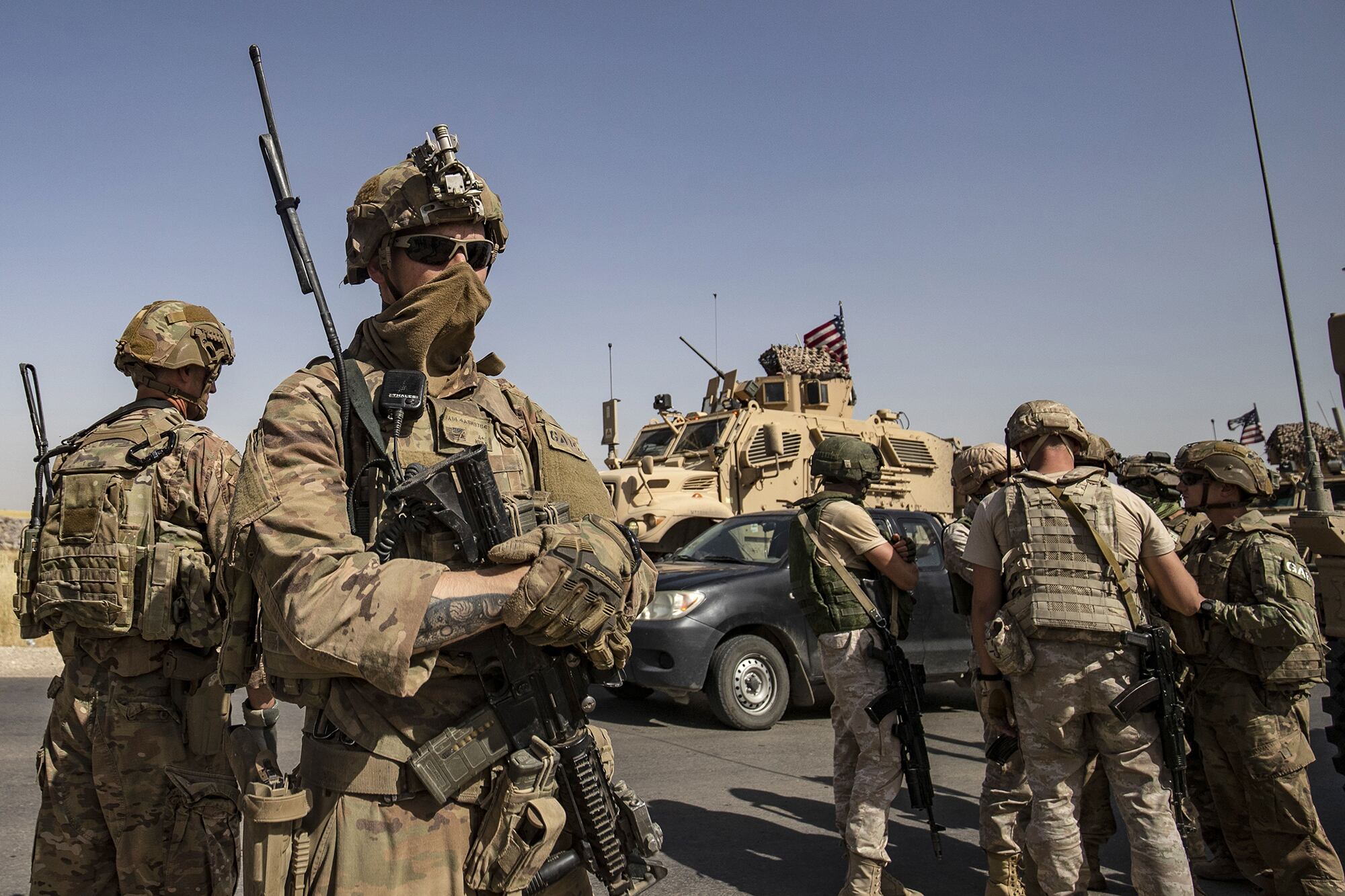 U.S. and Russian soldiers talk with each other in the northeastern Syrian town of al-Malikiyah (Derik) at the border with Turkey, on June 3, 2020