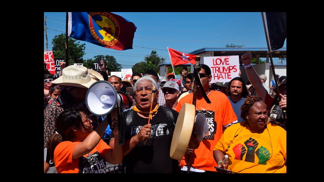 Dr. Cornel Pewewardy beats the drum and leads protesters as they march along Northwest Ozmun Avenue and onto Sheridan Road to the Fort Sill entry gates, Saturday, July 20, 2019 in Lawton, Okla
