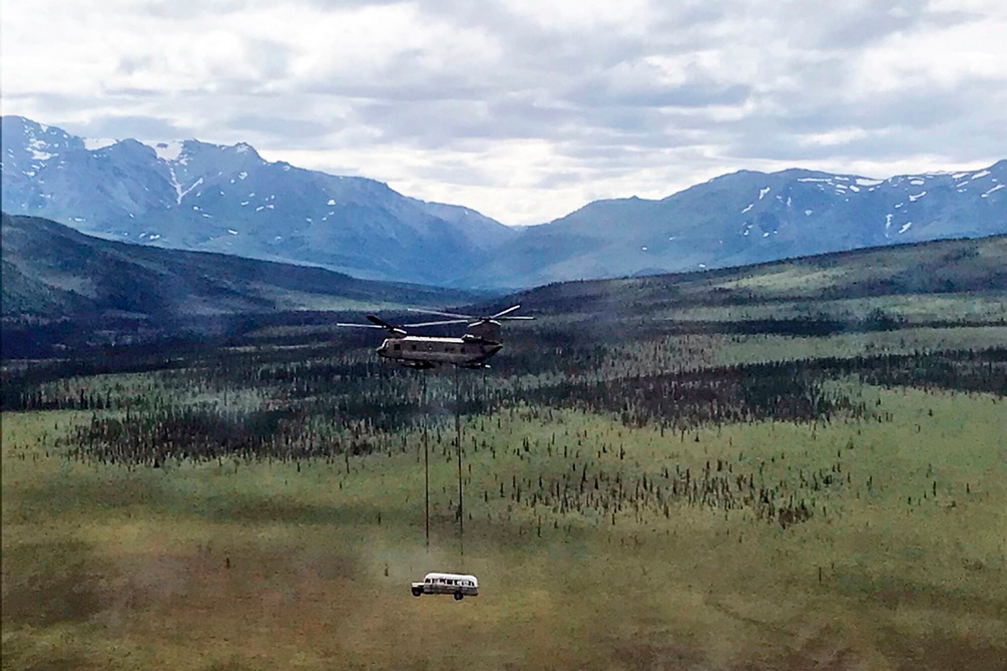 In this photo released by the Alaska National Guard, Alaska Army National Guard soldiers use a CH-47 Chinook helicopter to airlift an abandoned bus, popularized by the book and movie "Into the Wild," out of its location in the Alaska backcountry in light of public safety concerns, as part of a training mission Thursday, June 18, 2020.