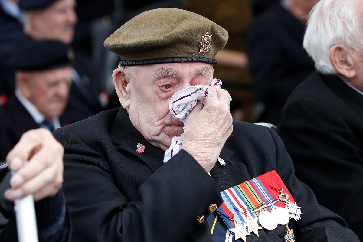 A veteran wipes his eyes during a ceremony to mark the 75th anniversary of D-Day