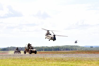 Alaska Air National Guard pararescue jumpers maneuver into position at the Malemute Drop Zone at Joint Base Elmendorf-Richardson, Alaska, July 10, 2020