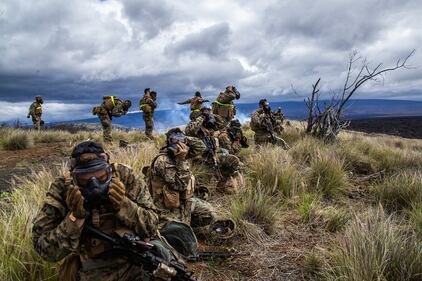 Marines prepare for a dose of compound 2-chlorobenzalmalononitrile "CS" gas during Exercise Bougainville II on Range 10, Pohakuloa Training Area, Hawaii