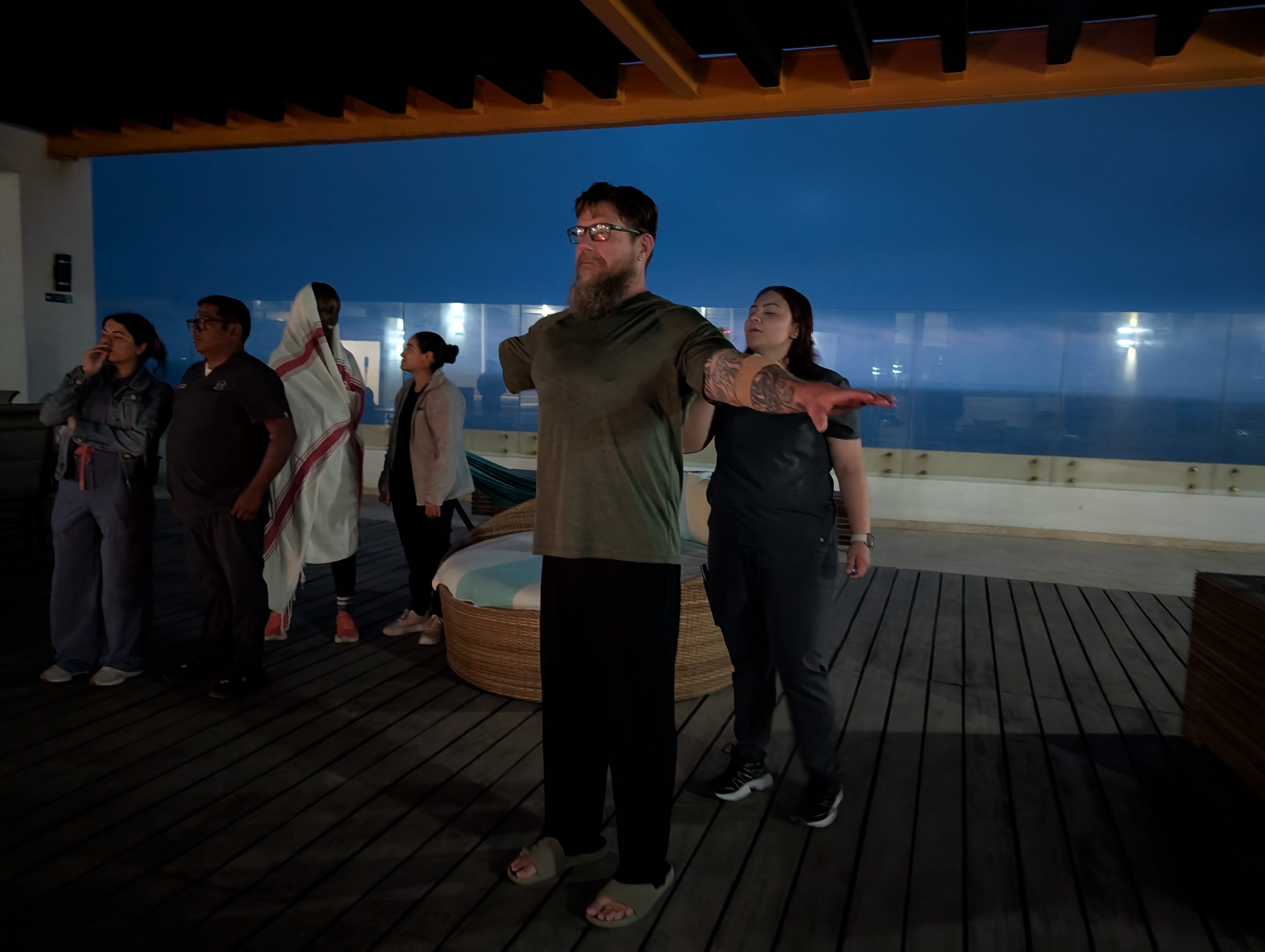 Ambio nurse Angie Serrano puts smoke from burning sage, a practice known as “smudging,” around Mark Dervaes’ body before he takes ibogaine. (Photo credit/Natanya Friedheim)