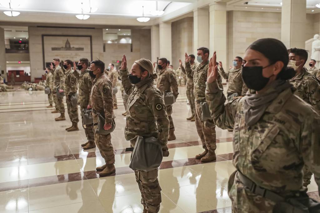 U.S. soldiers with the New Jersey National Guard take the oath of office to serve with Capitol Police in the Visitor Center at the U.S. Capitol in Washington on Jan. 13, 2021.