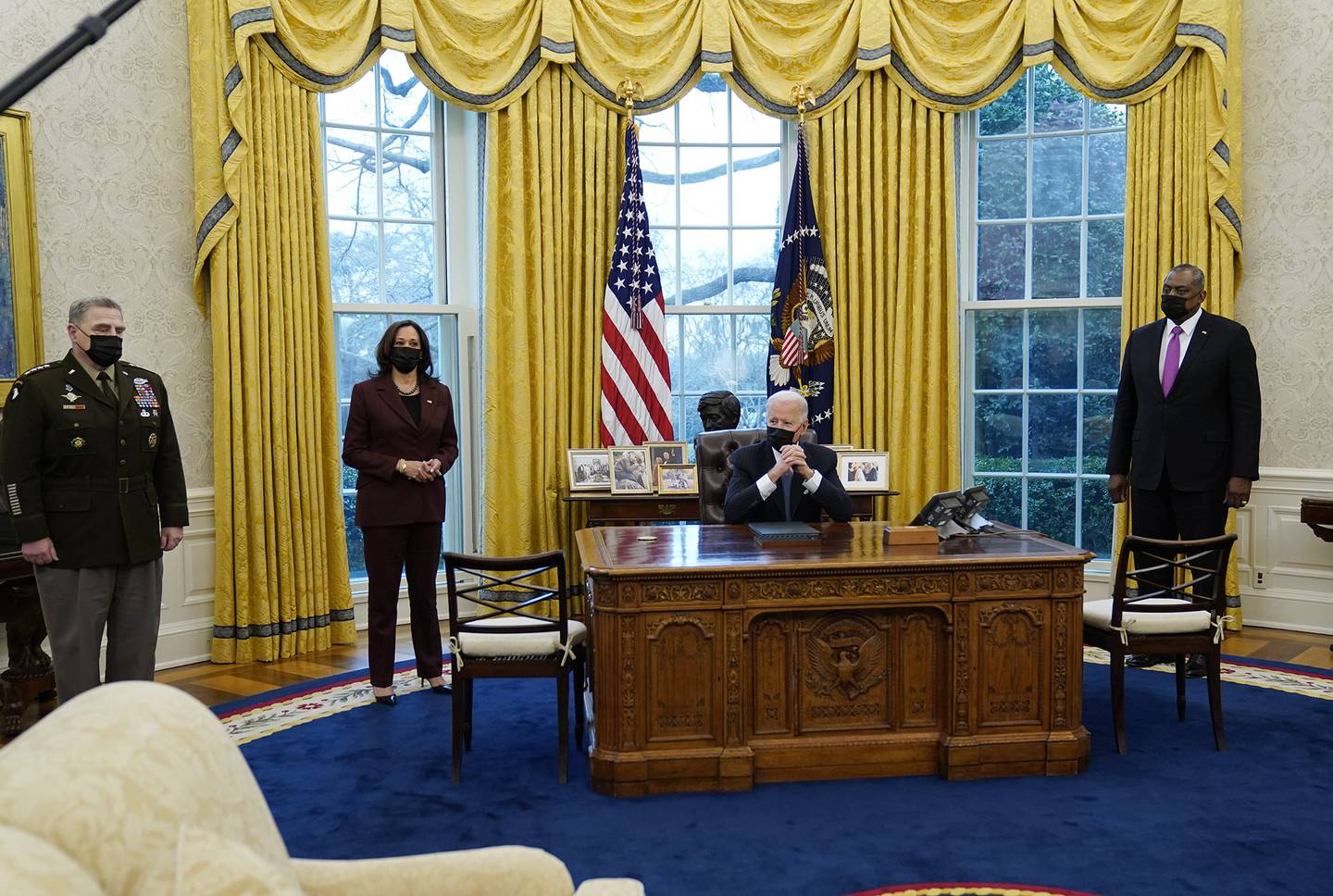 President Joe Biden meets with Secretary of Defense Lloyd Austin, right, Vice President Kamala Harris, and Gen. Mark Milley, chairman of the Joint Chiefs of Staff, left, in the Oval Office of the White House, Monday, Jan. 25, 2021, in Washington.