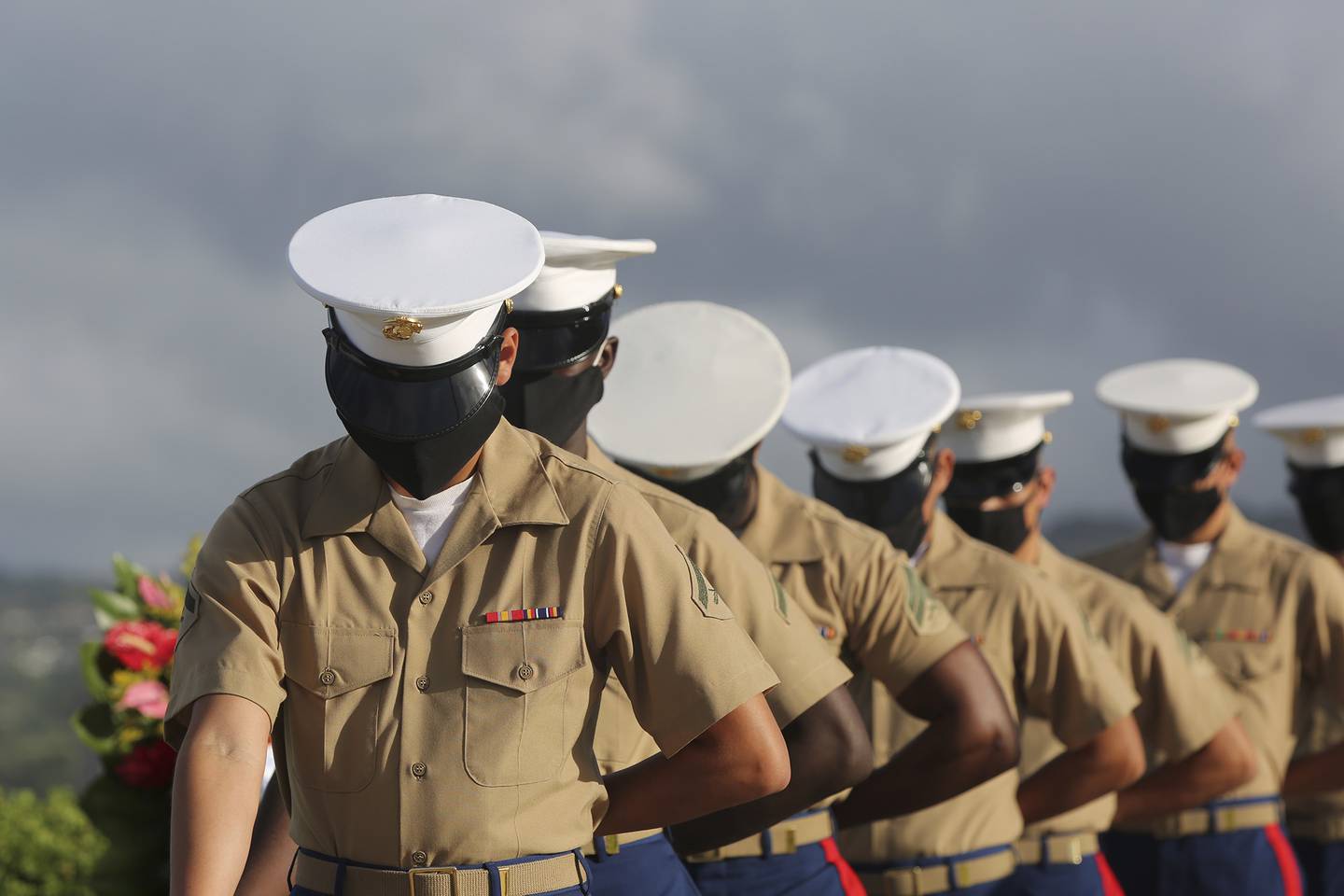 Marines wearing masks pause during a prayer at a ceremony marking the attack on Pearl Harbor, Monday, Dec. 7, 2020, in Pearl Harbor, Hawaii.