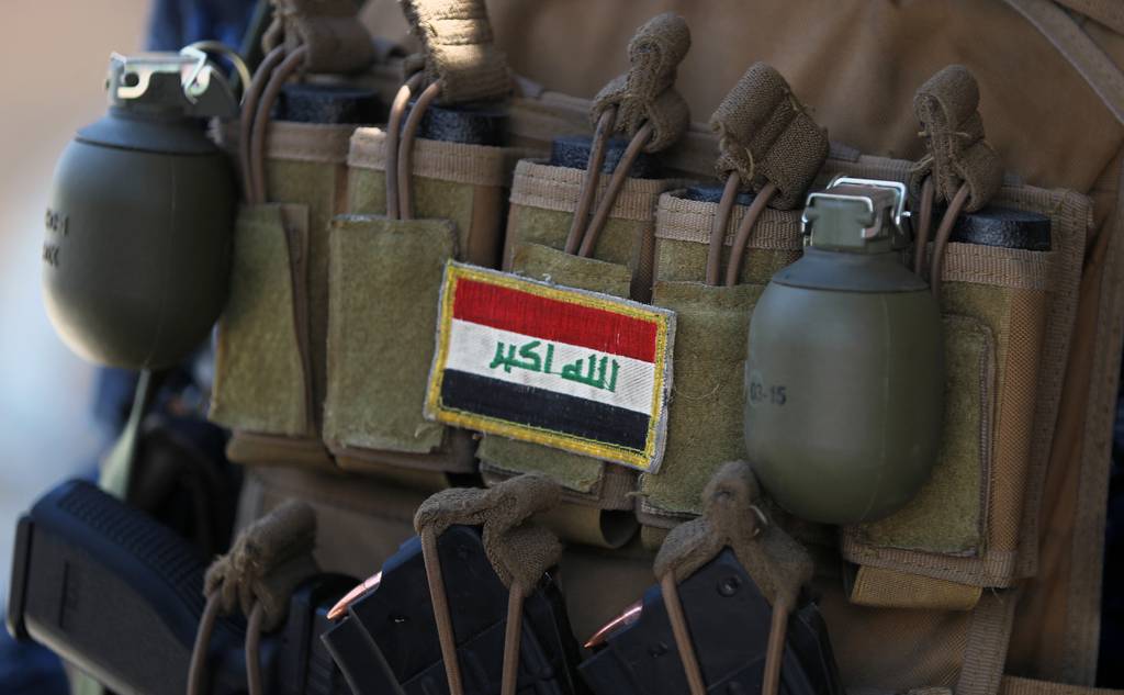 An Iraqi flag patched on the ammunition belt of a member of the Iraqi forces is seen June 19, 2017, during an offensive to retake the last district still held by the Islamic State group fighters in Mosul.