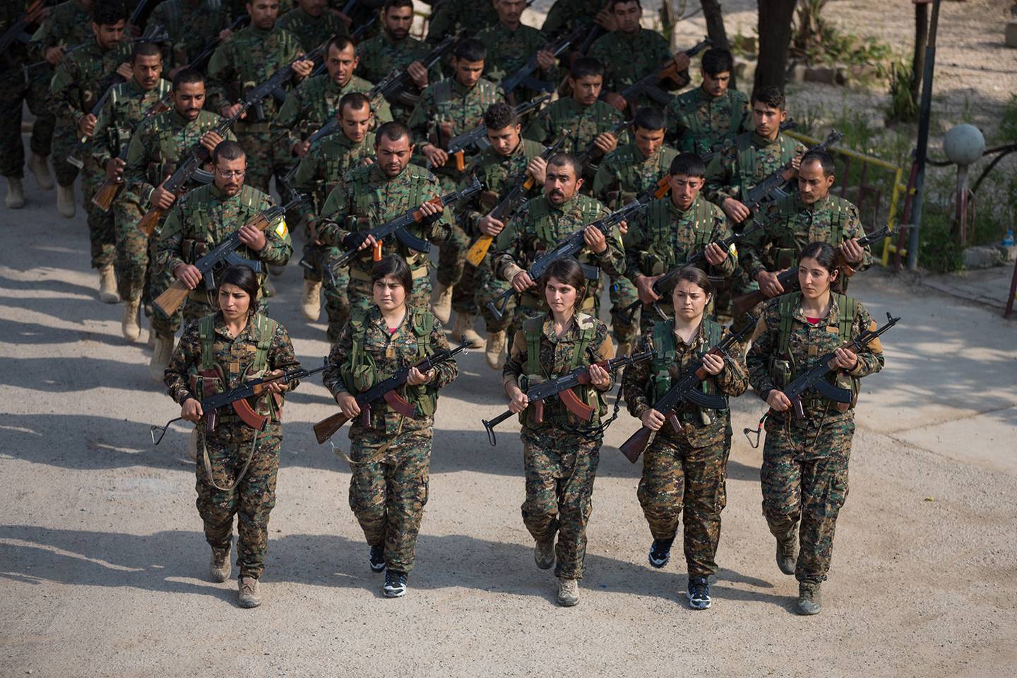 Members of the Syrian Democratic Forces stand in formation