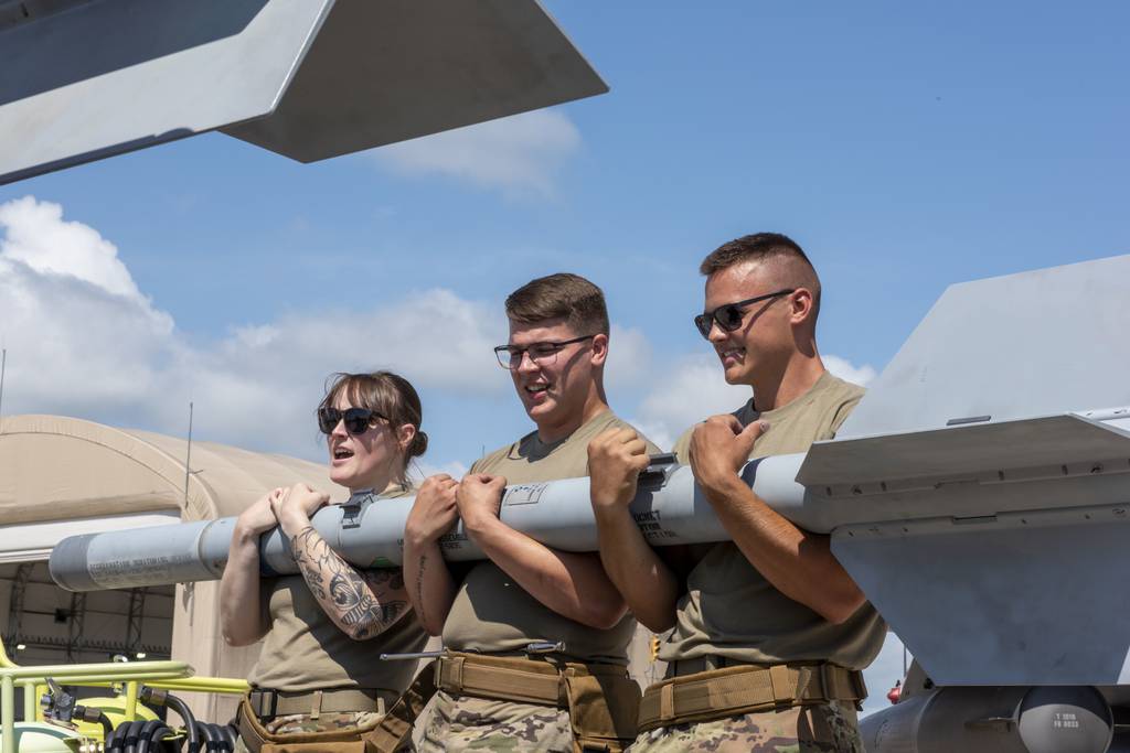 Tech. Sgt. Jordyn Rayot, Airman 1st Class Cole Whitmore and Airman 1st Class Jason Wilson, weapons loaders assigned to the 180th Fighter Wing, remove munitions from an F-16 Fighting Falcon during a training exercise in Swanton, Ohio, Aug. 2, 2022. The 180th FW is the only F-16 fighter wing in the state of Ohio, whose mission is homeland protection, effective combat power, and defense support to civil authorities, while developing airmen, supporting their families and serving in the community. (Tech. Sgt. John Wilkes/Air National Guard)