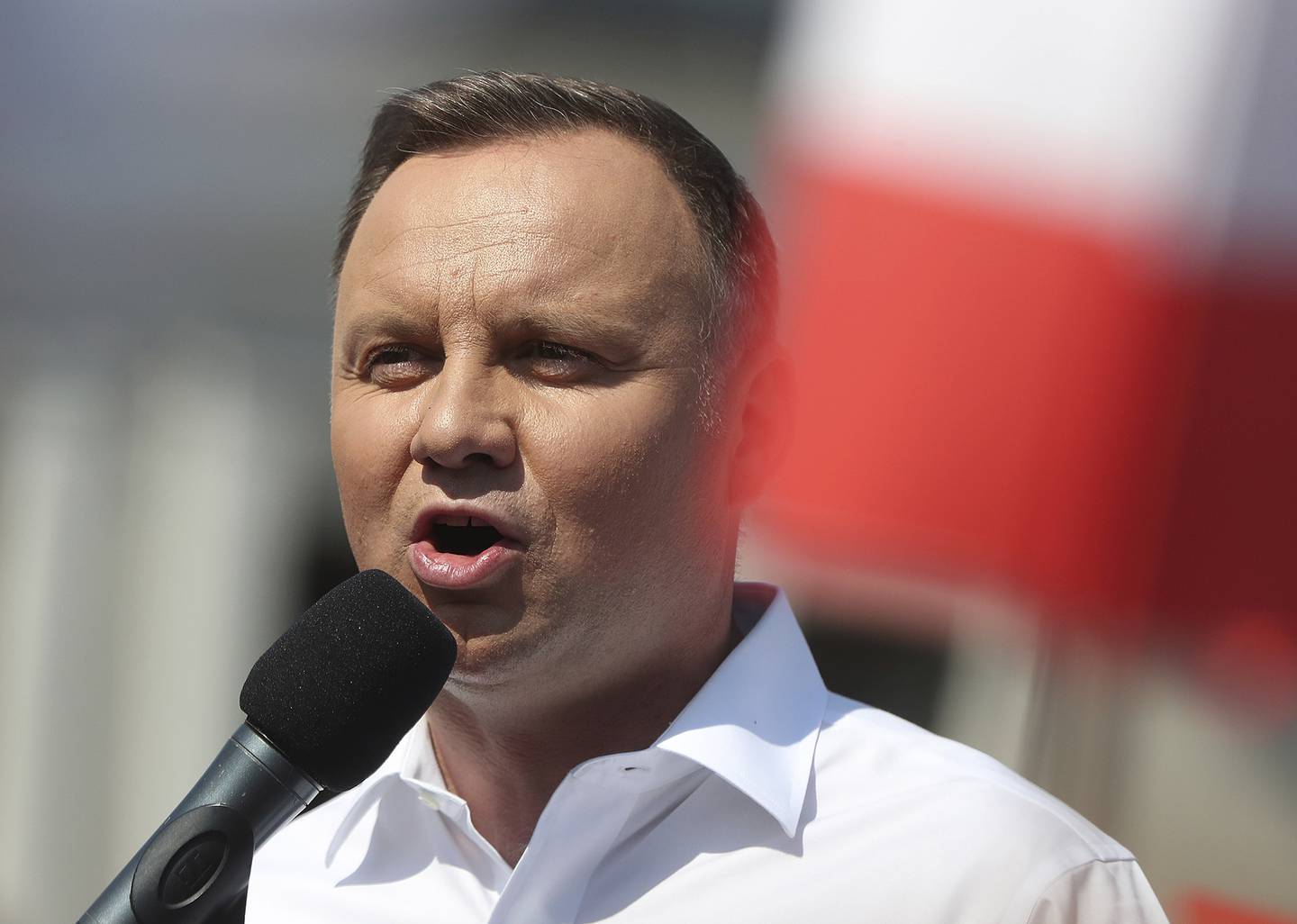 Polish President Andrzej Duda speaks to a crowd as he campaigns ahead of a presidential election later in this month, in Plonsk, Poland, on June 16, 2020.