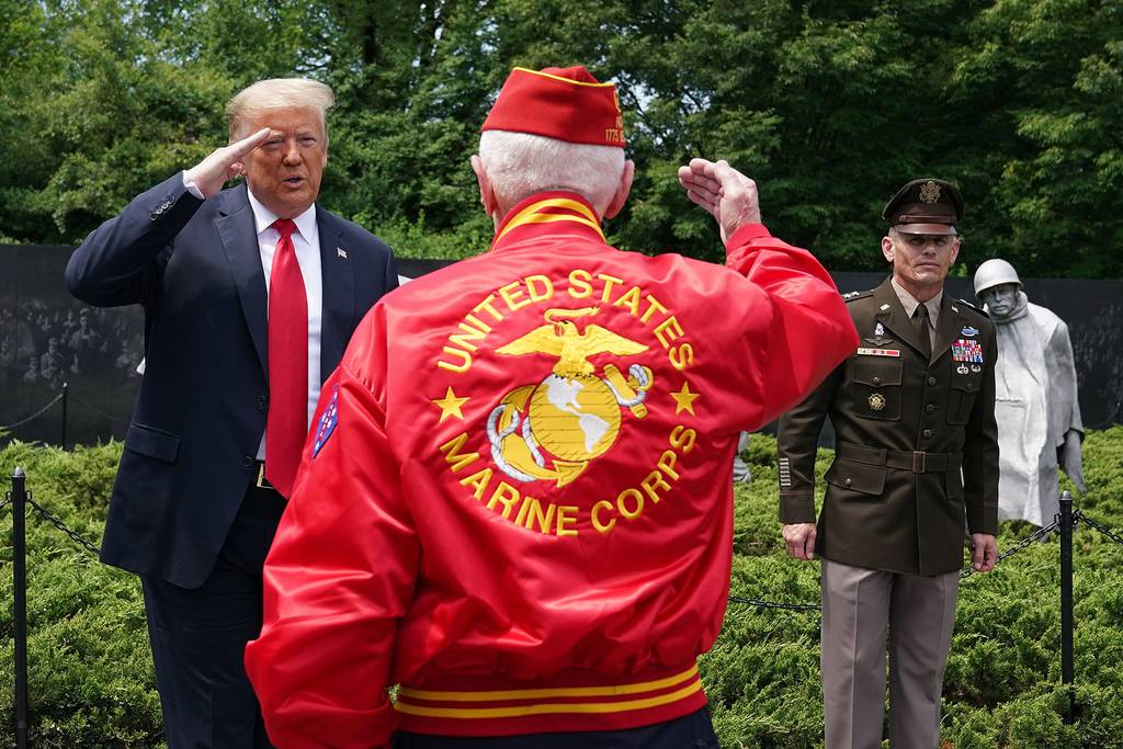 President Donald Trump salutes a veteran during a visit to the Korean War Veterans Memorial in Washington on June 25, 2020.