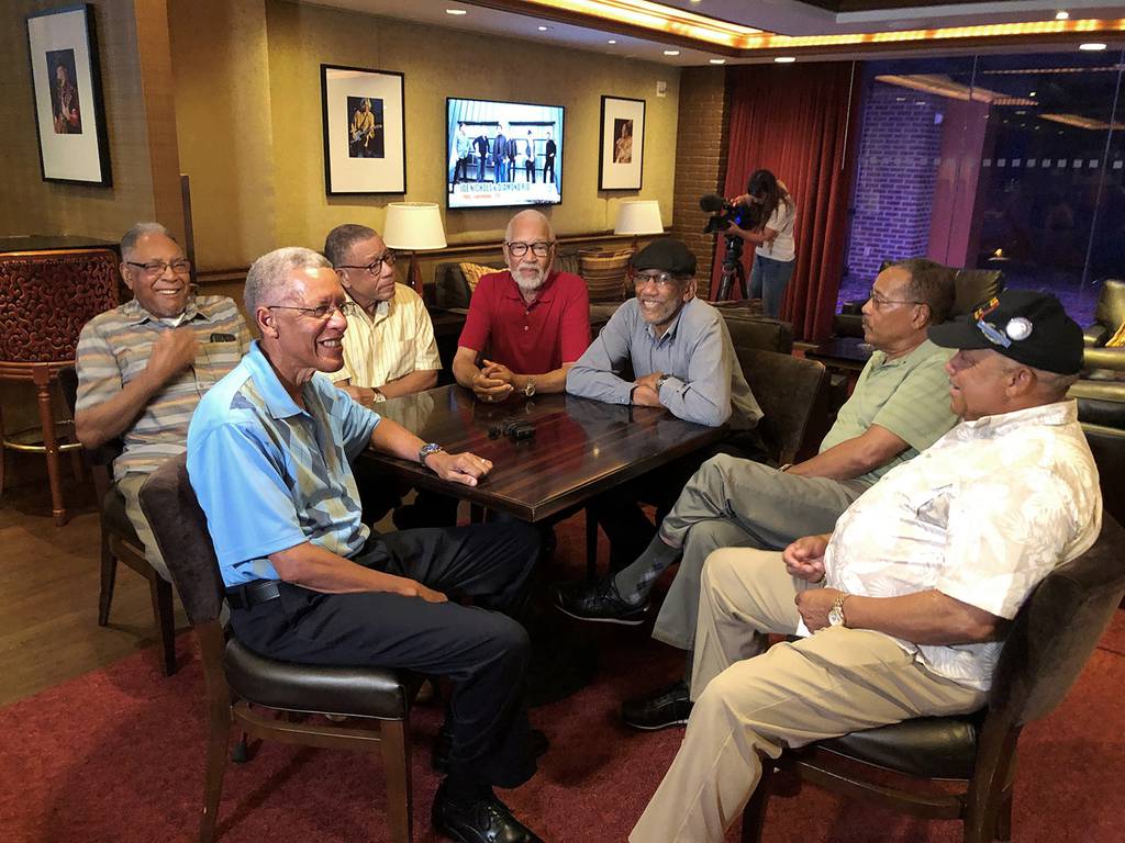Seven Davis brothers — Eddie, Frederick, Arguster, Octavious, Nathaniel, Julius and Lebronze — chat during a reunion at a hotel-casino on Friday, July 12, 2019 in Tunica, Miss.