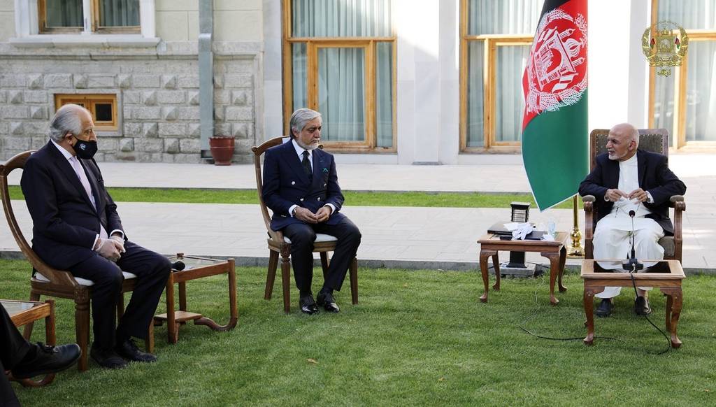 In this Wednesday, May 20, 2020, photo, Afghan President Ashraf Ghani, right, and fellow leader under a recently signed power-sharing agreement, Abdullah Abdullah, center, hold a meeting with U.S. peace envoy Zalmay Khalilzad aimed at resuscitating a U.S.-Taliban peace deal signed in February, at the Presidential Palace, in Kabul, Afghanistan.