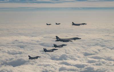 In this photo provided by South Korea Defense Ministry, U.S. Air Force B-1B bombers, F-16 fighter jets, South Korean Air Force F-15K fighter jets and Japanese Air Force F-2 fighter jets fly over South Korea's southern island of Jeju during a joint air drill, Wednesday, Dec. 20, 2023.