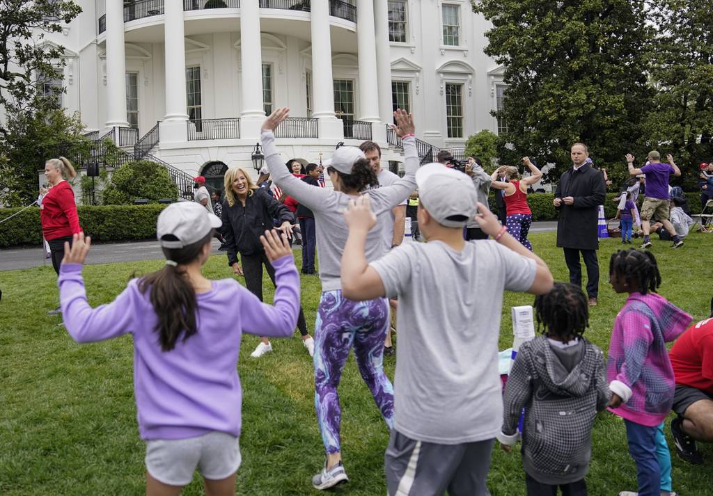 First lady Jill Biden walks though kids and families as they workout during the Joining Forces Military Kids Workout on the South Lawn of the White House in Washington, Saturday, April 29, 2023.
