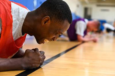 Airman 1st Class Sena Zohou, assigned to the 8th Communication Squadron, grimaces during the plank component portion of the Air Force’s physical fitness assessment beta test at Kunsan Air Base, South Korea, August 26, 2021. (Tech. Sgt. James Cason/Air Force)